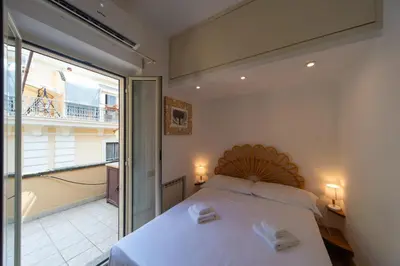 a bedroom with a bed and a balcony at My Monti Charming Holiday Home in Rome