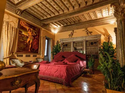 a dining room with a table and chairs and a chandelier at Giordano Segreto in Rome