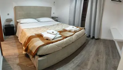 a bedroom with a large bed with towels on it at vatican house tolemaide ottaviano in Rome