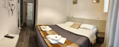 a hotel room with a bed with towels on it at vatican house tolemaide ottaviano in Rome
