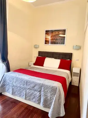 a bedroom with a large bed with a red blanket at Manrique home in Rome