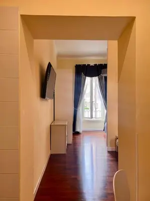 a living room with a window and a wooden floor at Manrique home in Rome