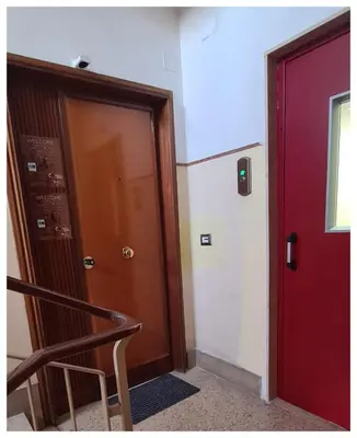 a room with two doors and a chair next to at Wanderlust Suite in Rome