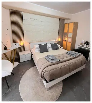 a bedroom with a large bed and a desk at Wanderlust Suite in Rome