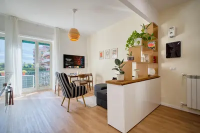 a living room with a table and a dining room at Pigneto Mood Comfort nel Cuore Creativo di Roma in Rome