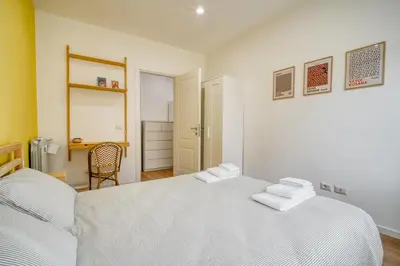 a bedroom with a white bed with two towels on it at Pigneto Mood Comfort nel Cuore Creativo di Roma in Rome