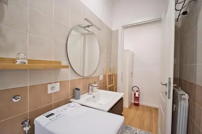 a bathroom with a sink and a mirror at Pigneto Mood Comfort nel Cuore Creativo di Roma in Rome