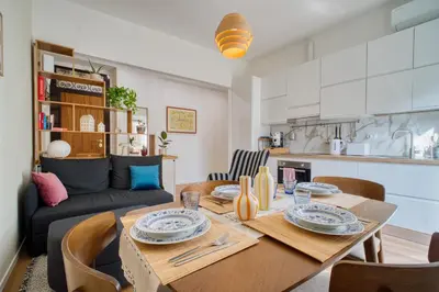 a dining room and living room with a table and chairs at Pigneto Mood Comfort nel Cuore Creativo di Roma in Rome