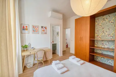 a bedroom with a desk and a bed and a table at Pigneto Mood Comfort nel Cuore Creativo di Roma in Rome