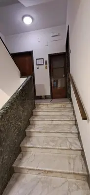 a staircase leading up to a hallway with a door at Casa Carmine in Rome