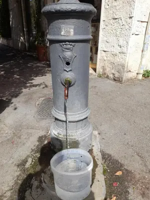 a water fountain with a bucket in front of it at Casa Carmine in Rome