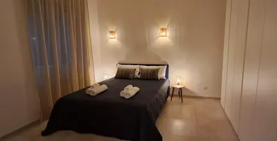 a bedroom with a bed with two towels on it at Casa Carmine in Rome
