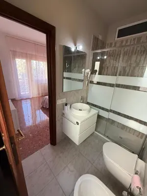 a bathroom with a white toilet and a sink at Casa Verde Roma in Rome