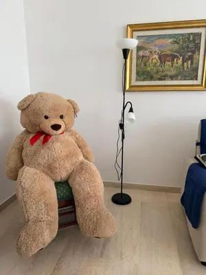 a large teddy bear sitting on a chair in a room at Casa Verde Roma in Rome