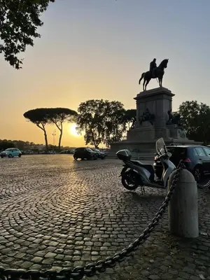 a motor scooter parked in front of a statue at Casa Verde Roma in Rome