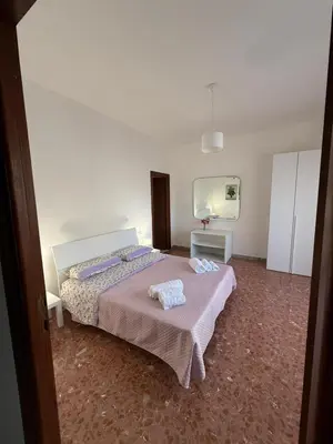 a bedroom with a bed with two towels on it at Casa Verde Roma in Rome