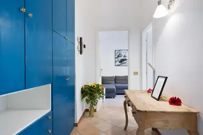 a living room with blue cabinets and a wooden table at Rome centre Vatican cozy apartment in Rome