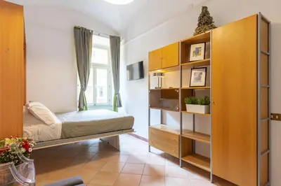 a bedroom with a bed and a book shelf at Rome centre Vatican cozy apartment in Rome
