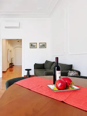 a bottle of wine and apples on a table at Merulana 13 in Rome