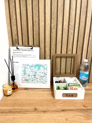 a box on a table with a map and a bottle of water at Charming Well Connected New Studio - Asia Sleeps in Rome