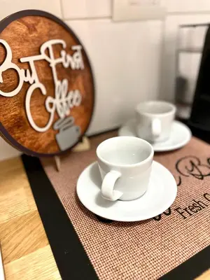 a table with two cups and a plate on it at Charming Well Connected New Studio - Asia Sleeps in Rome