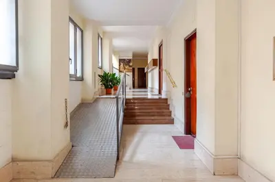 a hallway of a building with stairs and a gate at Charming Well Connected New Studio - Asia Sleeps in Rome
