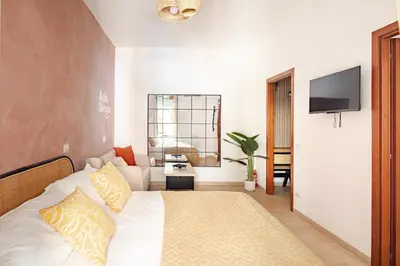 a hotel room with a bed and a television at Charming Well Connected New Studio - Asia Sleeps in Rome