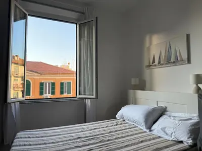 a bedroom with a bed and a large window at Cozy Home Flaminio in Rome