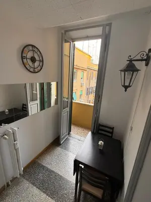 a hallway with a table and a mirror and a clock at Cozy Home Flaminio in Rome