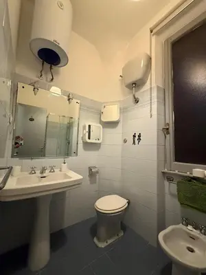 a bathroom with a sink and a toilet and a mirror at Cozy Home Flaminio in Rome