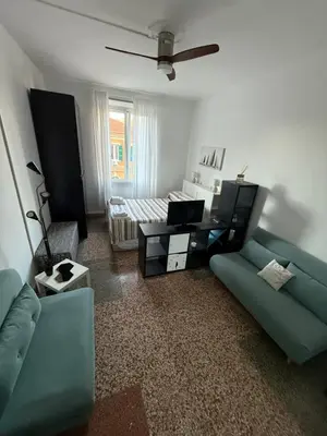 a living room with a blue couch and a table at Cozy Home Flaminio in Rome
