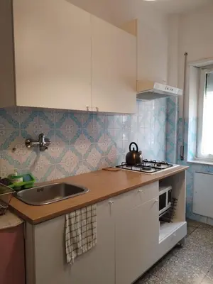 a kitchen with a sink and a counter top at Next Stop Roma Affittacamere Casilino in Rome