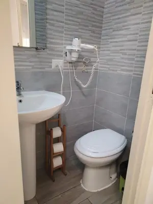 a bathroom with a toilet and a sink at Next Stop Roma Affittacamere Casilino in Rome