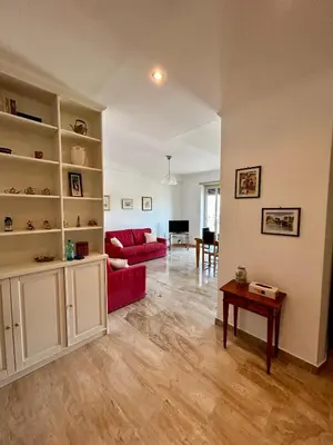 a living room with a red couch and a table at Casa vacanze Morabito in Rome