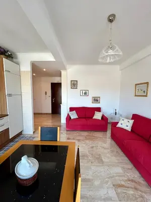 a living room with two red couches and a table at Casa vacanze Morabito in Rome