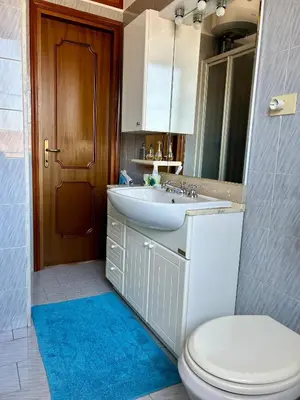 a bathroom with a sink and a toilet and a mirror at Casa vacanze Morabito in Rome