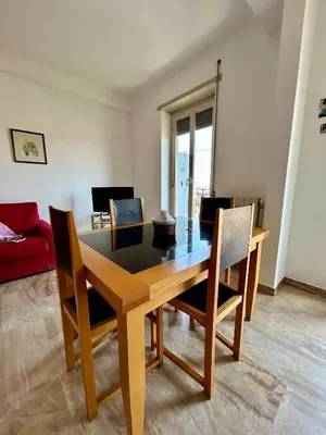 a dining room with a wooden table and chairs at Casa vacanze Morabito in Rome