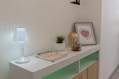a table with a lamp and a book on it at A Casa di Giò in Rome