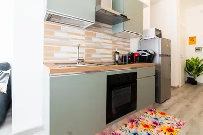 a kitchen with a sink and a stove at A Casa di Giò in Rome
