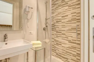 a bathroom with a sink and a shower at Casa Claudia Giulio Cesare in Rome