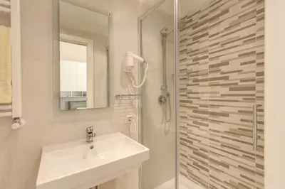 a white bathroom with a sink and a shower at Casa Claudia Giulio Cesare in Rome