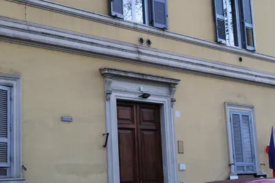 a building with a wooden door and windows at Casa Claudia Giulio Cesare in Rome