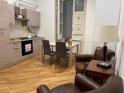 a kitchen and living room with a table and chairs at Casa Claudia Giulio Cesare in Rome