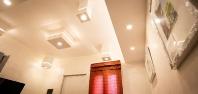 a hallway with recessed ceilings and a wooden door at Monteverde Charme -ROMA- in Rome