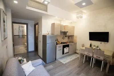 a kitchen and living room with a refrigerator and a table at Monteverde Charme -ROMA- in Rome