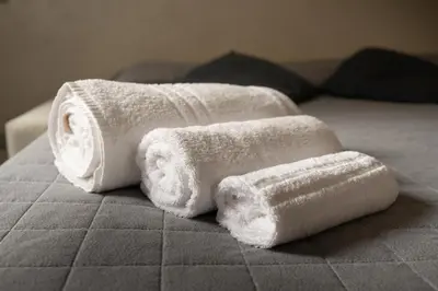 two towels sitting on top of a bed at Monteverde Charme -ROMA- in Rome