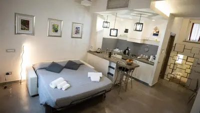 a bedroom with a bed and a kitchen with a sink at Monteverde Suite -ROMA- in Rome