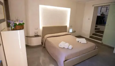a bedroom with a bed with two slippers on it at Monteverde Suite -ROMA- in Rome