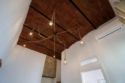 a room with a brick ceiling with lights at Castle Suite Borgo in Rome