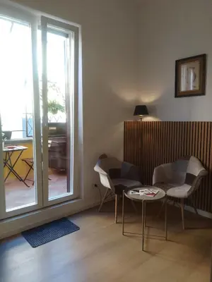 a living room with a table and chairs and a sliding glass door at Castle Suite Borgo in Rome